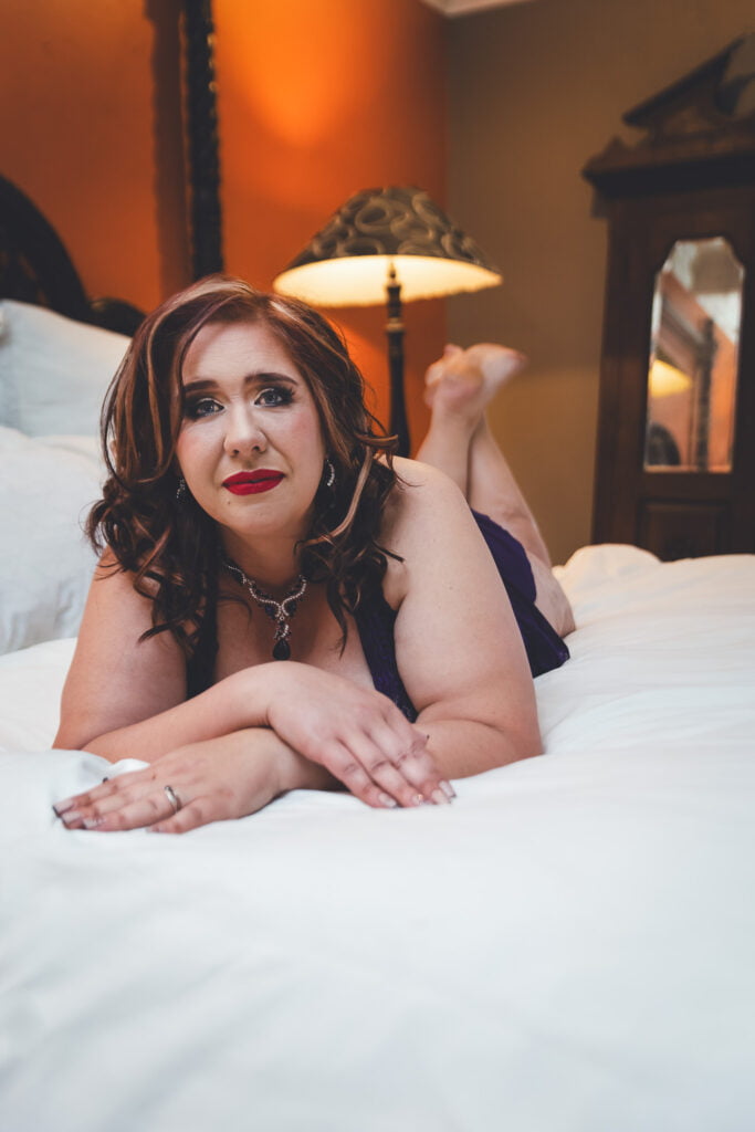 An image of a woman confidently posing in a boudoir setting, breaking stereotypes and challenging societal expectations